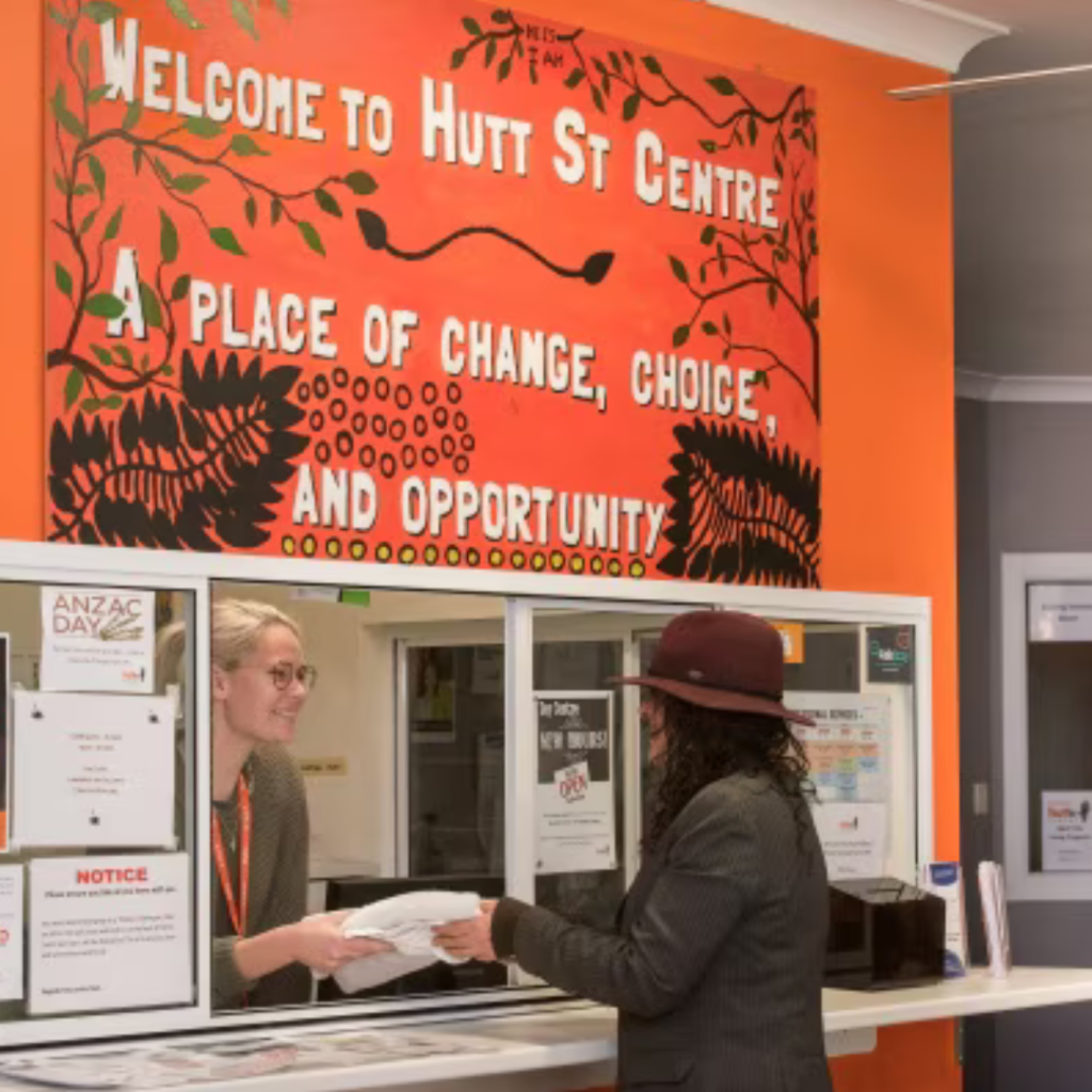 Woman stands at front desk of Hutt Street Centre in Adelaide